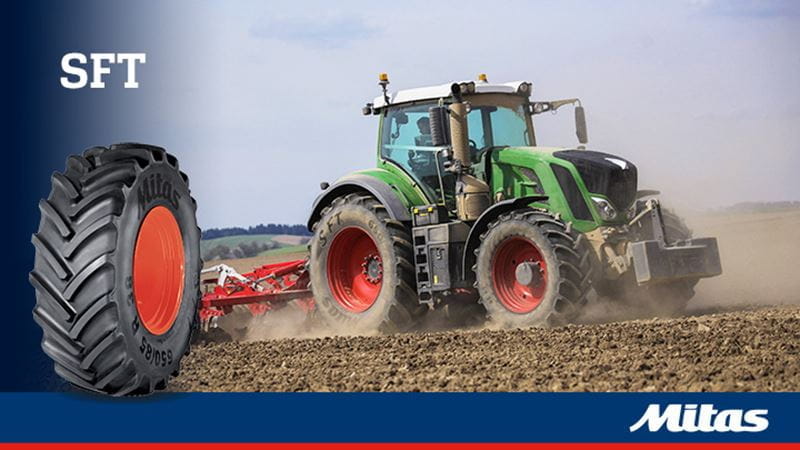 A harvester with Mitas SFT tires, showing the deep tread pattern and strong sidewall.