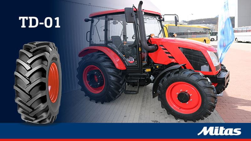 A tractor with Mitas tractor diagonal tires, showing the durable construction and wide tread pattern.